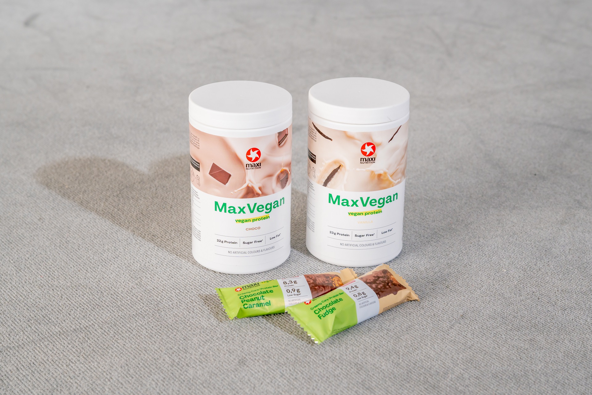 maxinutrition-maxvegan-und-vegan-creamy-core-protein-bar-auf-grauem-teppich